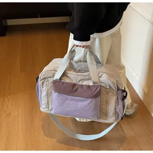 Large dry-wet separation gym bag carried by hand in a lifestyle setting