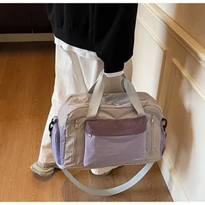 Detailed view of a trendy dry-wet separation travel gym bag held by a person indoors