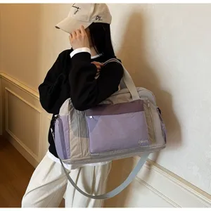 Spacious purple and grey sports gym bag with dry-wet separation carried by a model