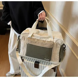 Large dry-wet separation travel bag held by person on a white suitcase luggage