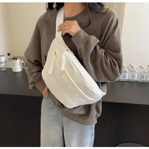 White minimalist canvas chest bag for women with embroidered detail in casual style