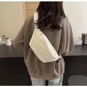 Minimalist white Japanese style chest bag shown as a crossbody detail on model