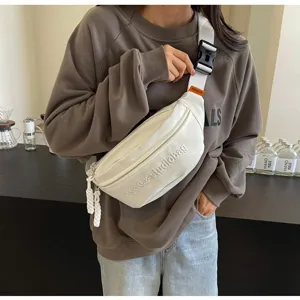 Minimalist white canvas chest bag for women in a stylish casual streetwear lifestyle look