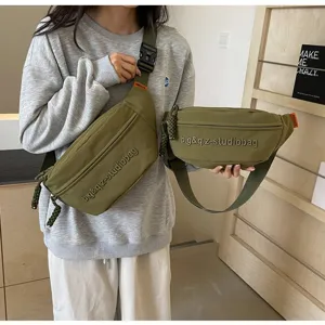Detailed view of two olive green minimalist multifunctional crossbody chest bags