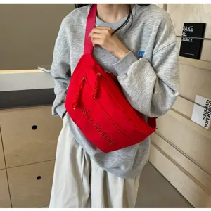 Red Japanese ins style crossbody chest bag shown on model in a casual setting