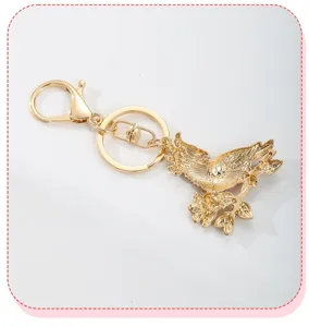 Detailed macro view showing the textured back of the golden parrot and flower bird keychain