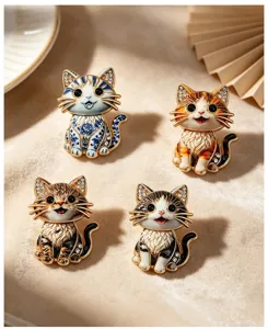 Macro detail of four cute cartoon cat brooches in various enamel patterns and colors