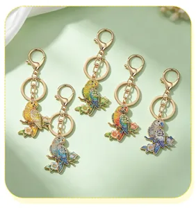 Detailed collection of five colorful enamel parrot keychains with sparkling rhinestone accents