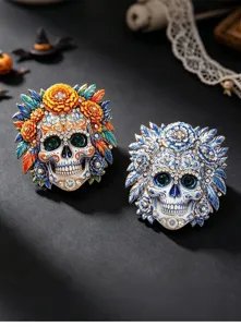 Detailed view of two ornate sugar skull brooches with crystals and colorful enamel flowers