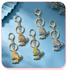 Detailed view of five colorful enamel parrot keychains with sparkling rhinestones