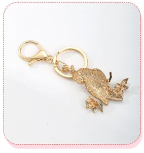 Detailed back view of a golden parrot bird keychain featuring a textured metallic finish