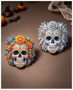 Detailed view of Day of the Dead skull brooches with floral patterns and rhinestones.