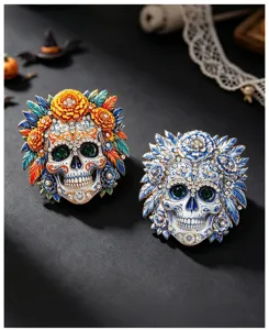 Macro detail of ornate Day of the Dead skull brooches with colorful enamel and gems.