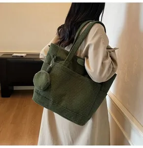 Detailed view of large vintage green corduroy tote bag with matching coin purse pouch