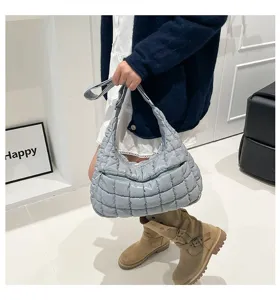 Light blue quilted puffer cloud bag shown in a stylish streetwear outfit context