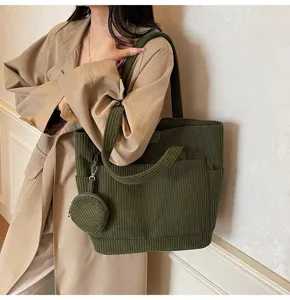 Retro dark green corduroy tote bag featuring a small coin purse shown in detail.
