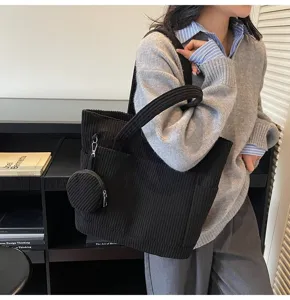 Detail view of stylish black corduroy large capacity tote bag with matching coin pouch.
