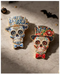 Detailed view of Mexican Day of the Dead skull brooches with flowers and top hats.