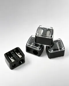 Close-up detail view of black dual-hole makeup pencil sharpener with transparent lids