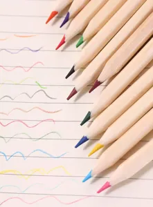 Detailed macro view of assorted colored pencils with matching squiggly lines on paper