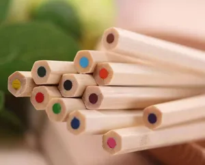 Close-up detail of natural wood hexagonal colored pencils showing vibrant lead ends.