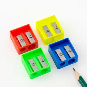 Colorful plastic double hole pencil sharpener detail view, portable stationery tool.