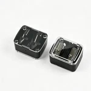 Detailed top view of two professional black dual-hole manual pencil sharpeners with lids