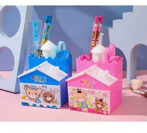 Detail showing blue and pink house-shaped stationery sets for kids with pencils and rulers