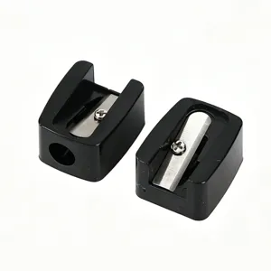 Macro view of two mini black single-hole sharpeners for eyebrow and lip makeup pencils