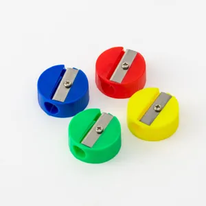 Detailed view of four colorful mini round pencil sharpeners in blue, red, green, and yellow
