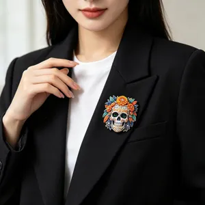 Day of the Dead sugar skull brooch with colorful enamel flowers and rhinestones on black blazer