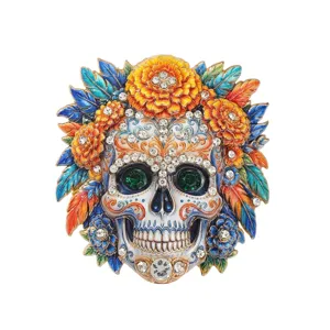 Exquisite Day of the Dead skull brooch decorated with vibrant flowers and sparkling crystals