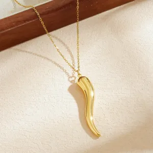 Close-up of a polished gold-plated stainless steel chili pepper pendant necklace