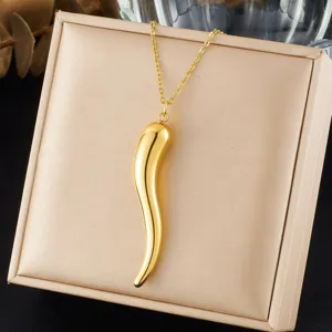Close-up of a gold-plated stainless steel chili pendant necklace on a beige jewelry box