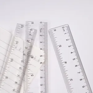 Transparent plastic ruler close-up detail, clear scale markings for drawing art and student stationery.