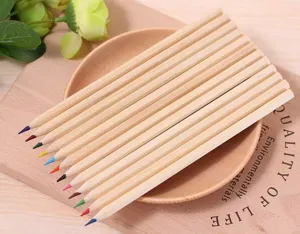 Set of 12 natural wood colored pencils displayed on a rustic wooden plate prop