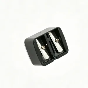 Detailed close-up view of a black double-hole manual sharpener for eyeliner and brow pencils