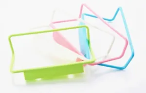 Detailed view of colorful door-back towel racks in pink, blue, white, and green.