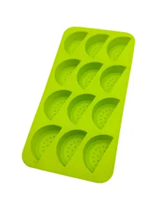 Detailed close-up showing the 12 watermelon slice cavities of the green silicone baking mold