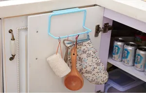 Detail showing a blue door-back towel rack hanging on a white kitchen cabinet door