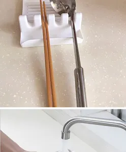 Close-up detail showing the white plastic kitchen utensil rest with multiple card slots for spoons.