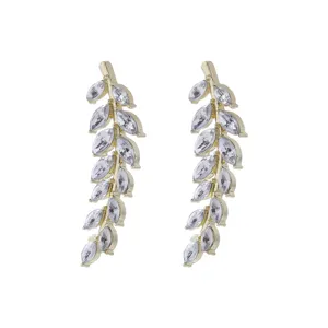 Detail shot of elegant gold-tone wheat spike earrings with sparkling marquise crystals.