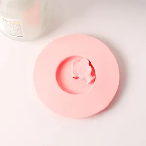 Close-up detail of a pink food-grade silicone cup lid with a flower-shaped handle