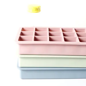 Detail shot of three stacked 15-compartment silicone ice cube trays in pastel colors.