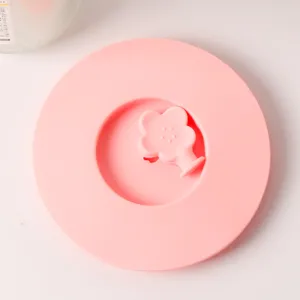 Detailed top view of a pink food-grade silicone cup lid with a cute flower handle