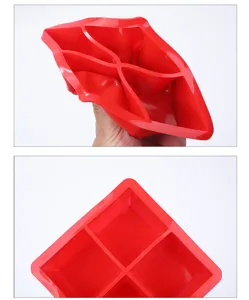 Detail view of a flexible red food-grade silicone 4-cavity square ice cube mold