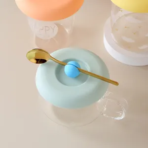 Creative silicone glass cup lid featuring bell handle and spoon holder for coffee mugs