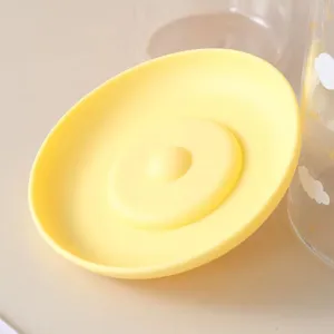 Soft yellow food-grade silicone cup lid with center dot design for dust-proof use