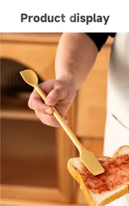 Detailed view of dual-ended silicone spatula spreading jam on toast