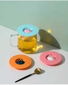 Detail view of creative cat ear silicone mug lids in pastel colors for dustproof use.